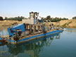 Stationary dredge with submerged pump